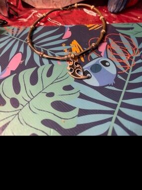 chunky choker-style necklace with a tribal-style metal pendant and bead accents.